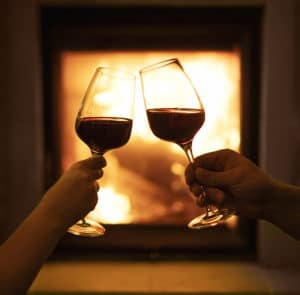 Two glasses of wine on the background of the fireplace, at the best places to stay in Duluth MN